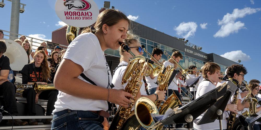 Show band students play during a football game